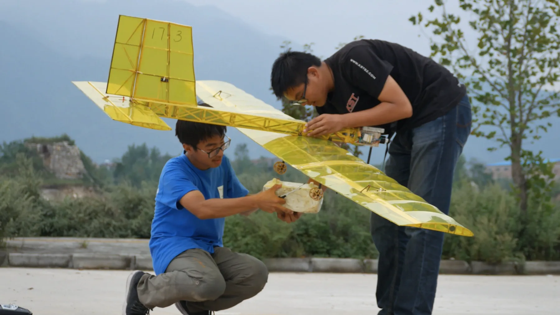 Team members integrating the ultra-light cargo aircraft and its payload