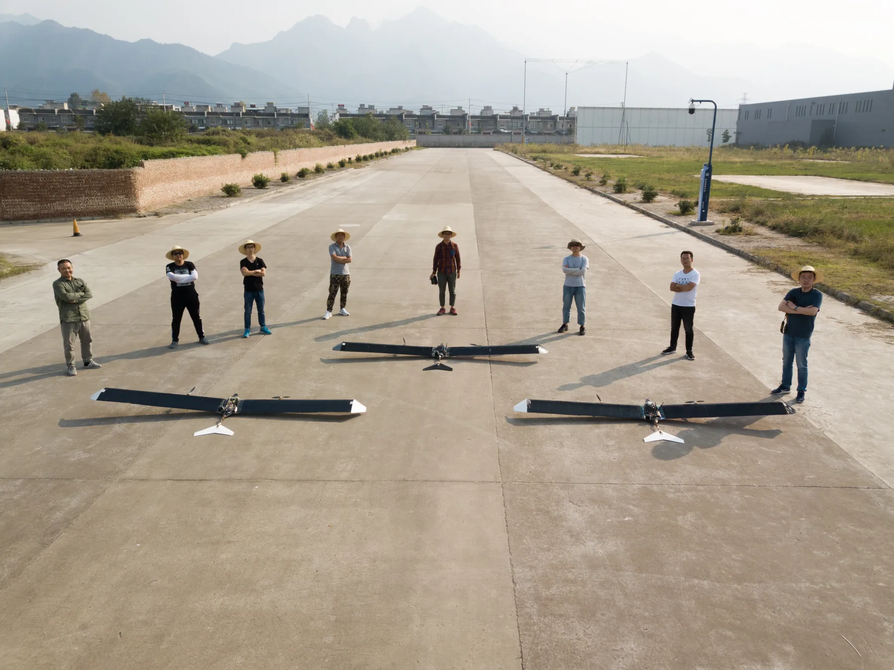 Liming Zheng and the aircraft team with three bio-inspired solar aircraft during field tests