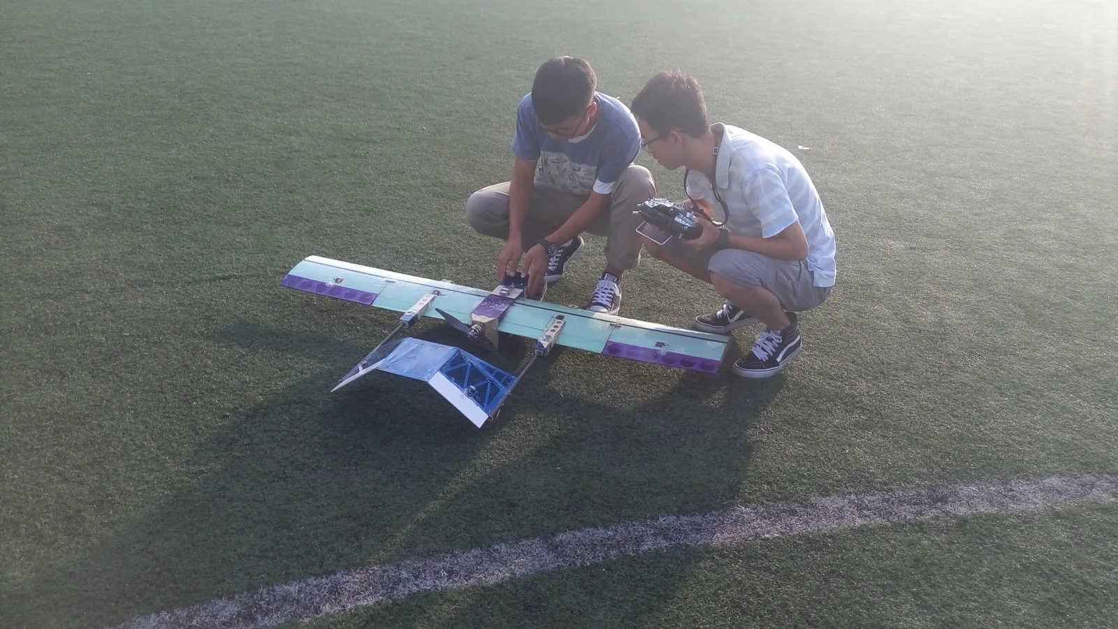 Liming Zheng checking the foldable reconnaissance aircraft before take-off