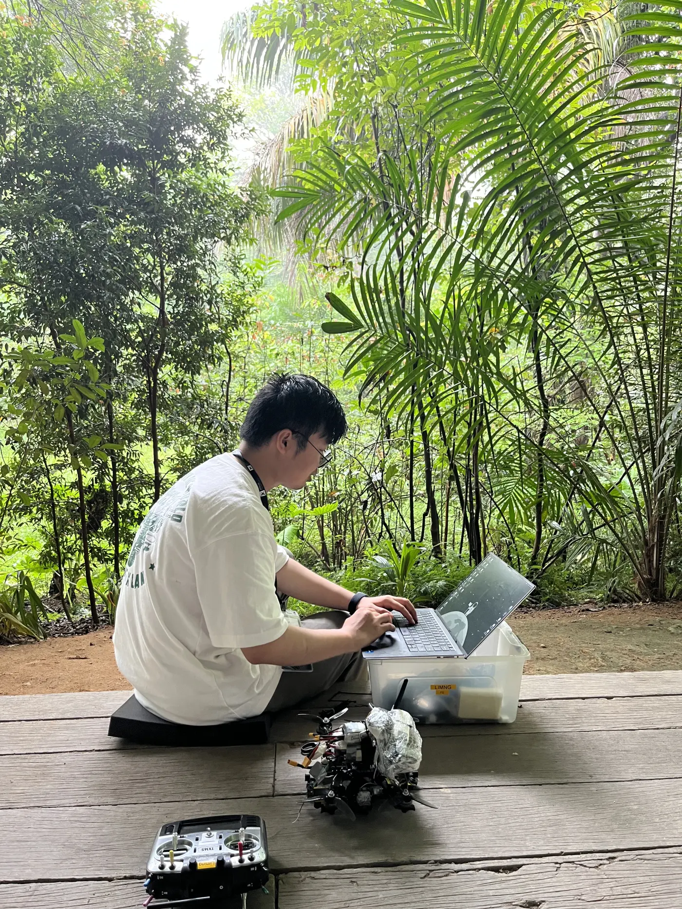 Liming Zheng tuning the perching drone in a Singapore rainforest