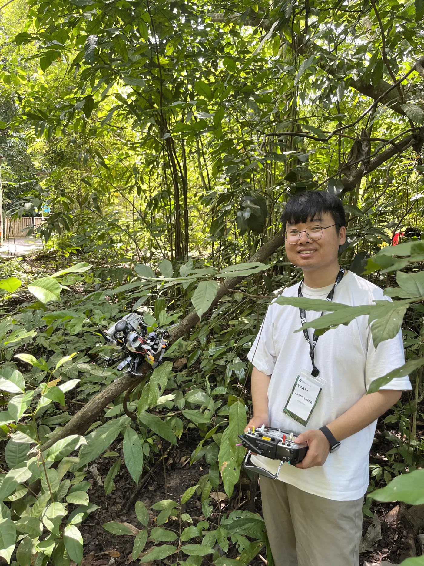 Liming Zheng beside the drone after a successful branch perch